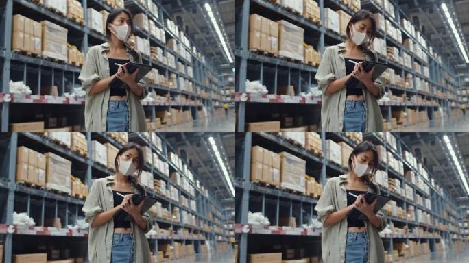 年轻的亚洲女商人经理戴着口罩在零售购物中心使用数字平板电脑检查库存水平寻找商品。