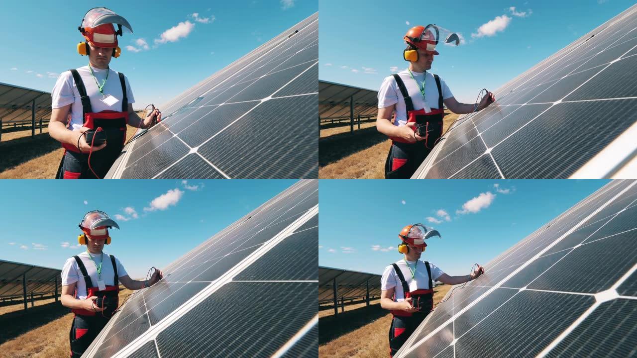 太阳能专家用万用表监控太阳能电池板。替代，绿色能源工作者。