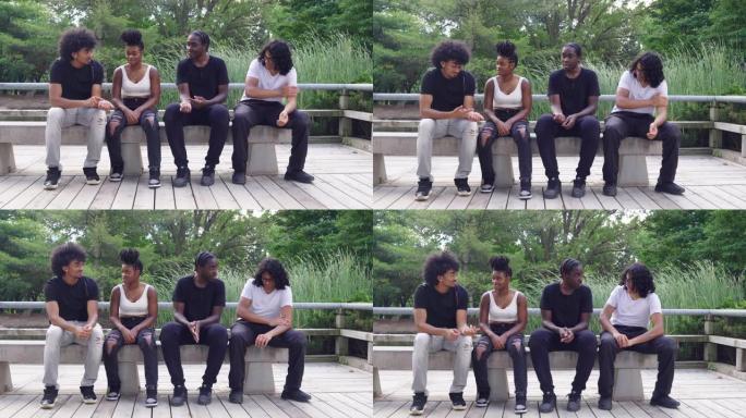 跨种族的朋友在公园的长凳上闲逛