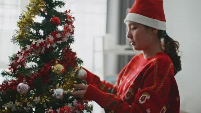 装饰圣诞树的亚洲女人