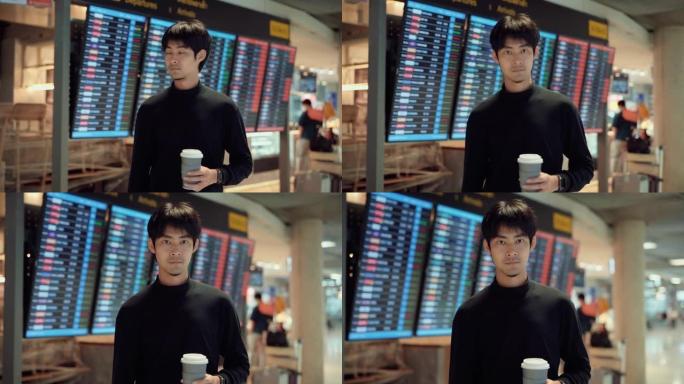 亚洲游客手持咖啡杯站在机场航站楼