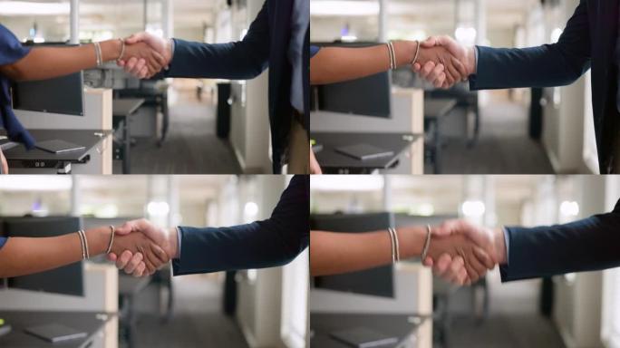 握手、伙伴关系和商务人士在办公室有交易、协议或合作。专业公司员工握手在工作场所入职、问候或欢迎的特写
