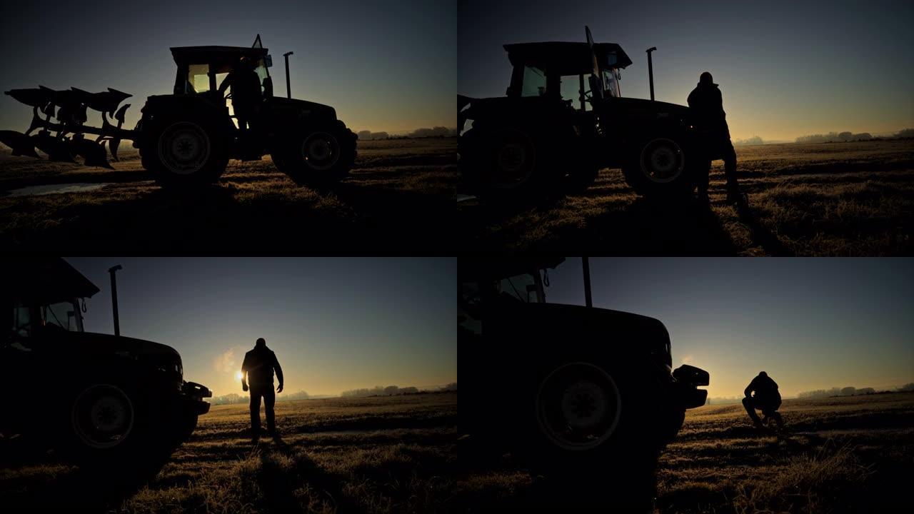 剪影农民在日落时分从农村的拖拉机上出来