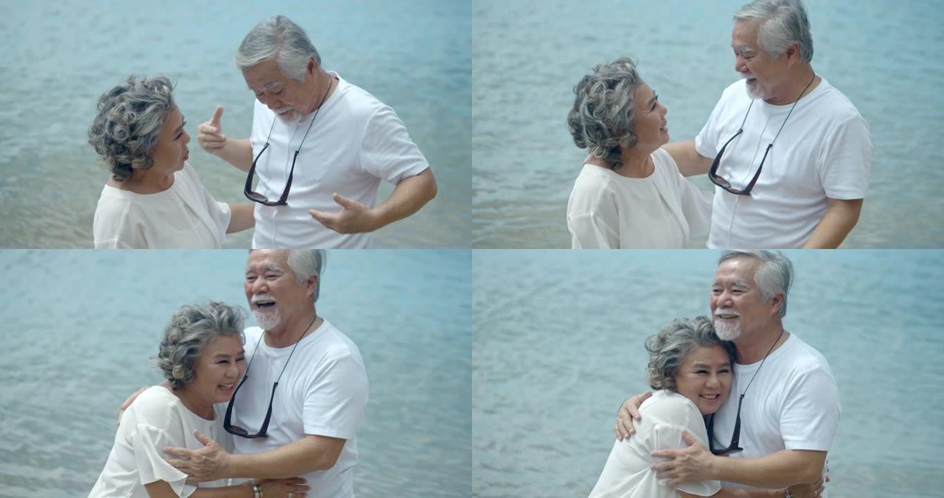 亚洲高级夫妇在海滩上拥抱，慢动作