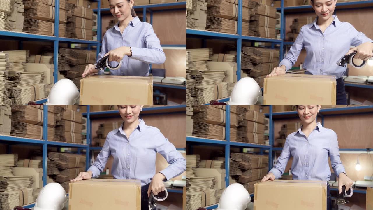 4K UHD掌上电脑: 亚洲美丽迷人的女性仓库工人在仓库配送中心包装包裹。在企业仓库物流概念中的应用