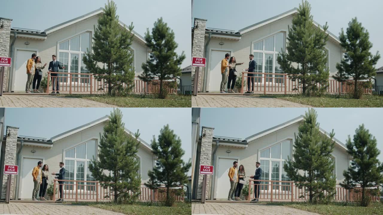 女孩和男孩和房地产经纪人聊天，看着郊区的房子，欣赏风景