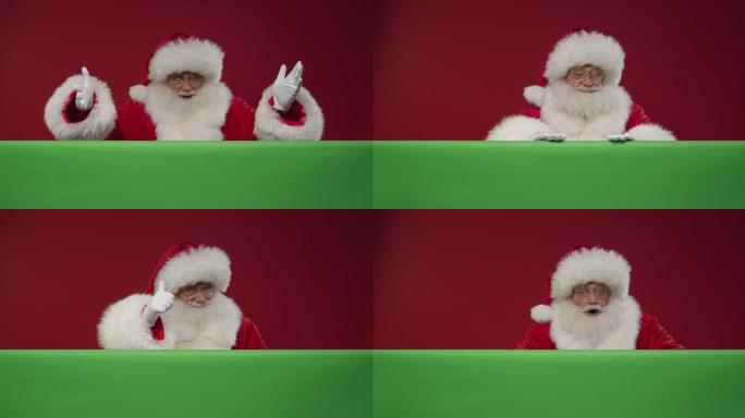 高兴的圣诞老人从他面前的绿色屏幕后面出现在红色背景上，然后躲在后面