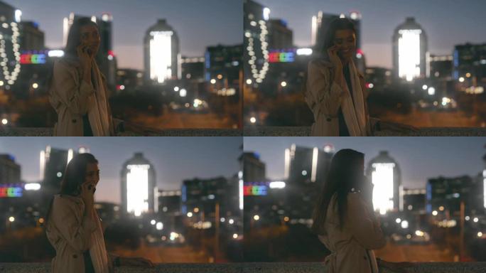 4k视频片段，一名妇女晚上在城市的屋顶上在手机上聊天