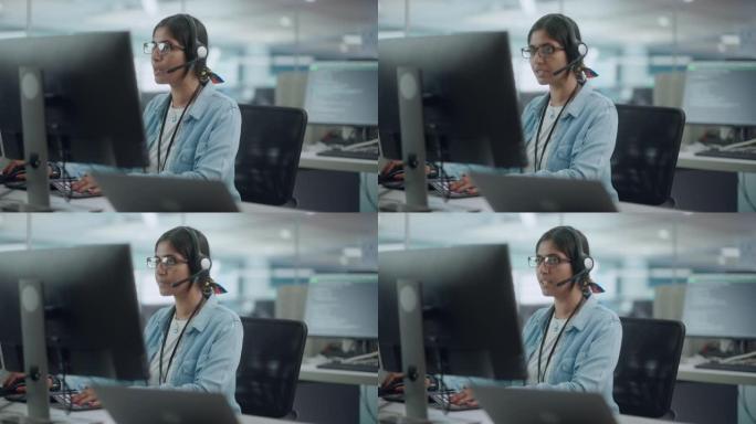 呼叫中心办公室: 友好的印度女性IT客户支持专家的肖像，在计算机上工作，与客户交谈，解决问题，寻找软