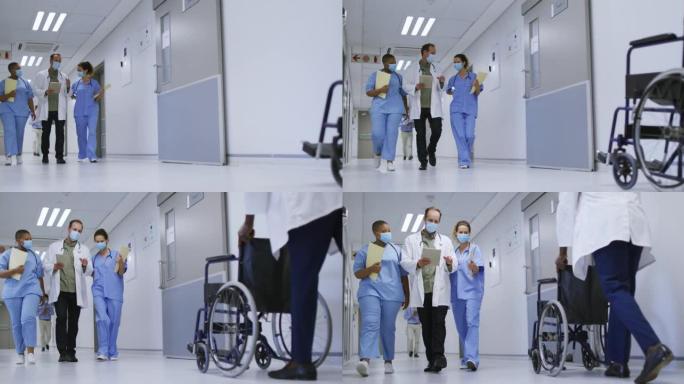 戴着口罩的男女医生在医院走廊散步