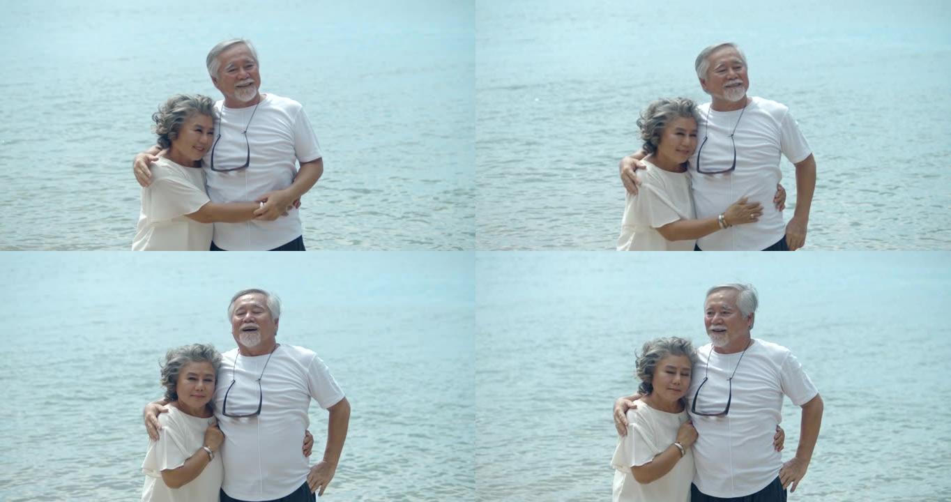 亚洲高级夫妇在海滩上拥抱，慢动作