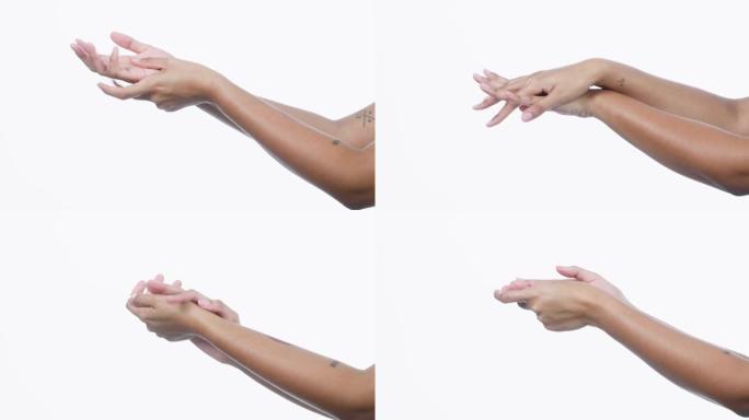 4k视频片段，一个无法识别的女人在白色背景上摩擦她的手