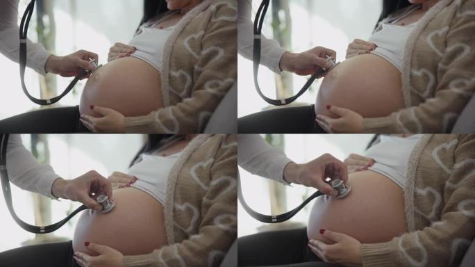 DS无法识别的男性产科医生使用听诊器听到婴儿的心跳