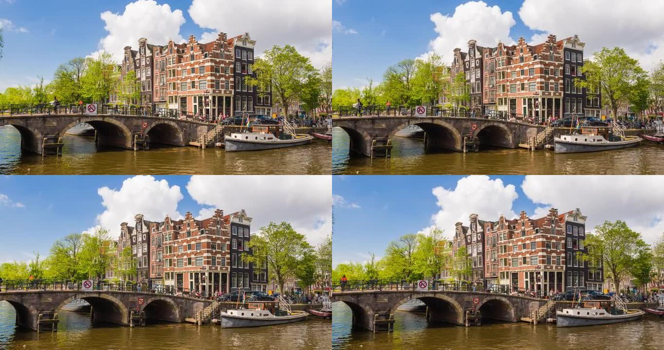 在一个美丽的阳光明媚的日子里，荷兰阿姆斯特丹有船只和倾斜房屋的运河景观