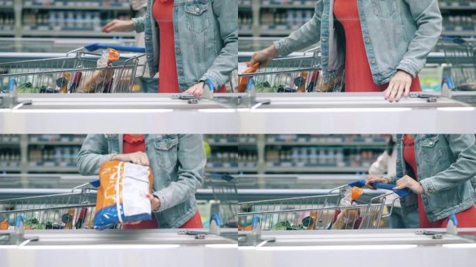 一名妇女正在将冷冻食品放入超市手推车中