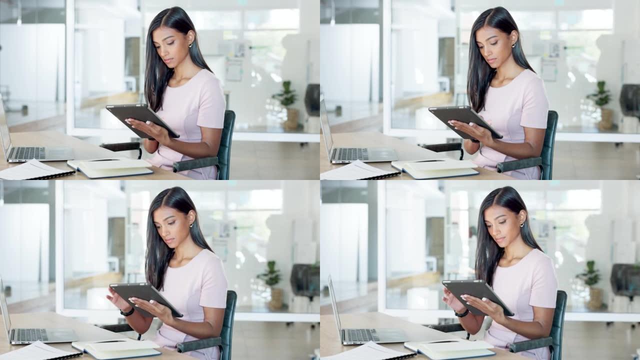 年轻的女实习生在现代办公室的平板电脑上看着，打字和检查社交媒体。员工坐在办公桌前浏览Facebook
