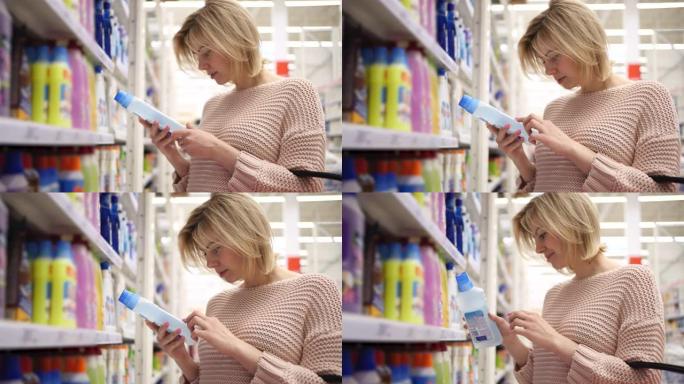 一个30多岁自信的女性买家看起来正在挑选家用化学品货架室内商店。帅气女孩专注搜索出售生物瓶必需品。手