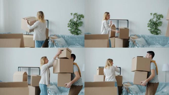 夫妻在搬迁到新房子期间携带纸箱搬运物品