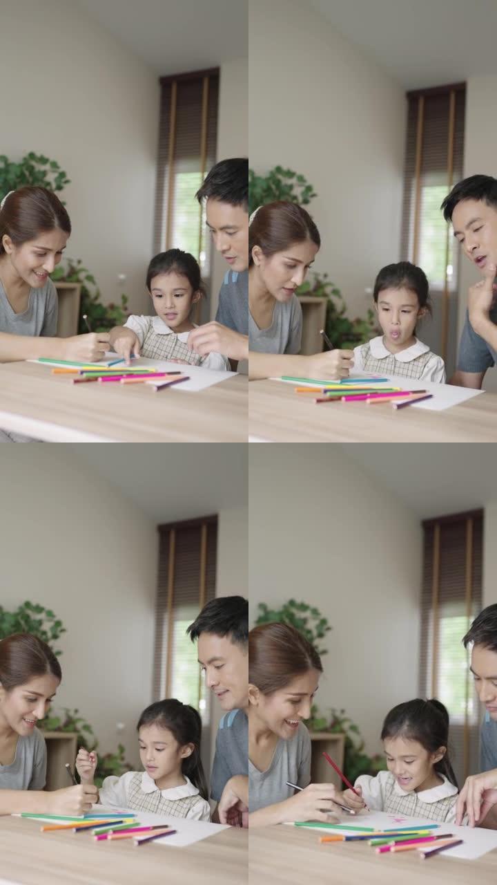 亚洲家长协助女儿美术作业的垂直视频。