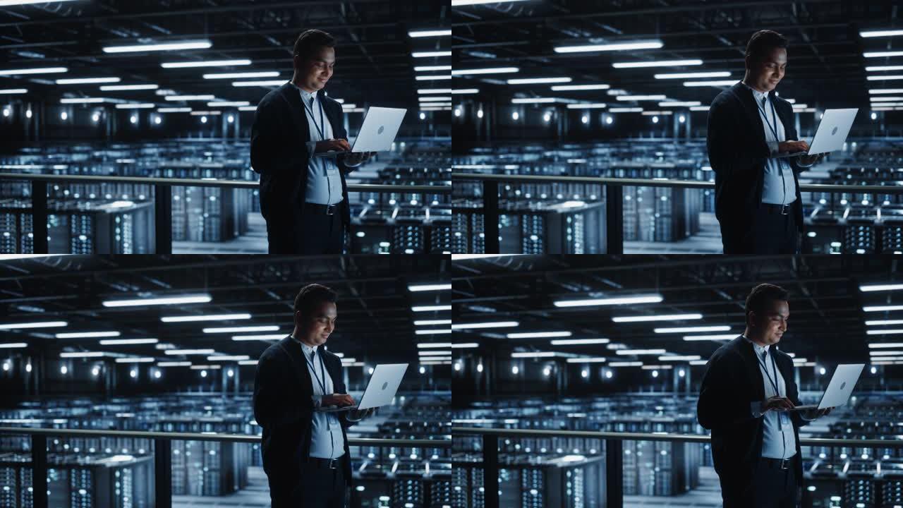 IT专家的肖像在数据中心使用笔记本电脑。服务器场云计算设施，男性系统管理员工作。网络安全和网络保护。
