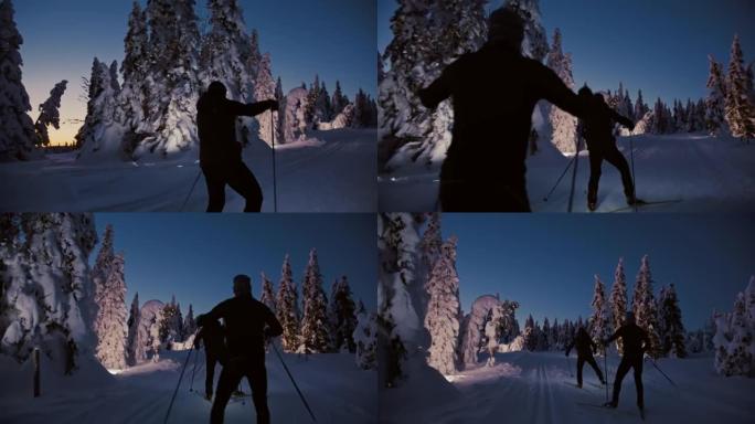 SLO MO两名越野滑雪者在夜间用大灯在山上的赛道上滑雪