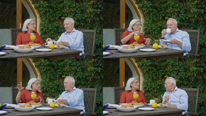 深情的高级夫妇在户外享用早餐