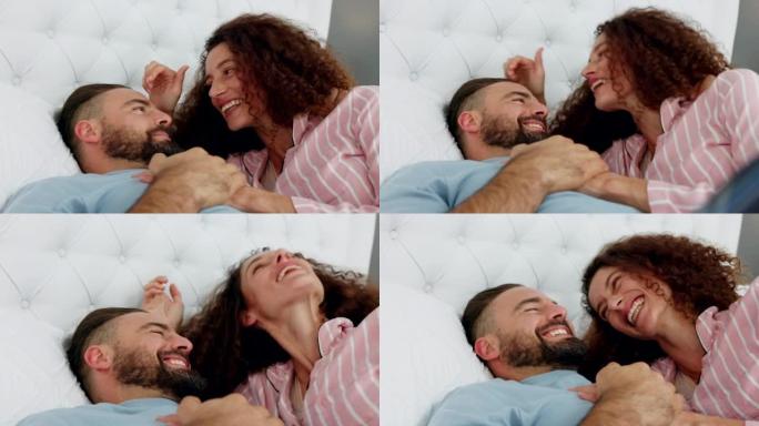 夫妻在床上的有趣，爱与亲吻一起醒来或在卧室里度过早晨的谈话，结合和大笑。快乐，浪漫和已婚的人，男人和