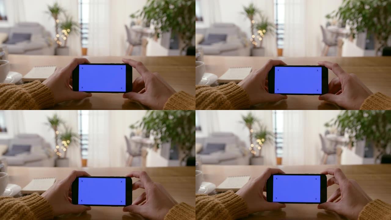 CU无法识别的人挥舞着色度键蓝屏的智能手机