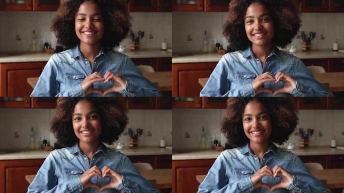 幸福的千禧黑人女性制作合指心形图形