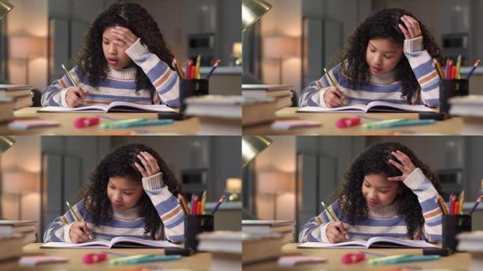 4k视频片段，一个年轻女孩独自坐在家里，在做作业时感到沮丧