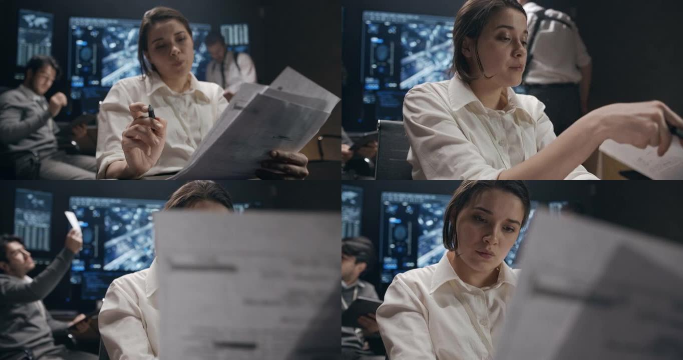 一个穿着白衬衫的年轻女子正在计算机上工作