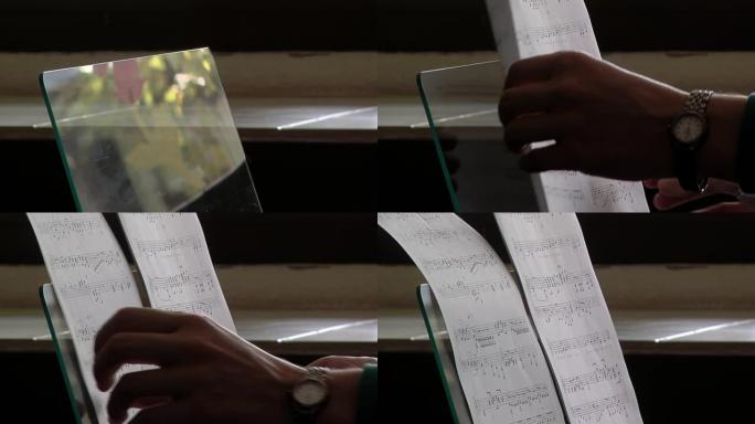 女性手将钢琴乐谱放在室内乐谱支架上。特写。