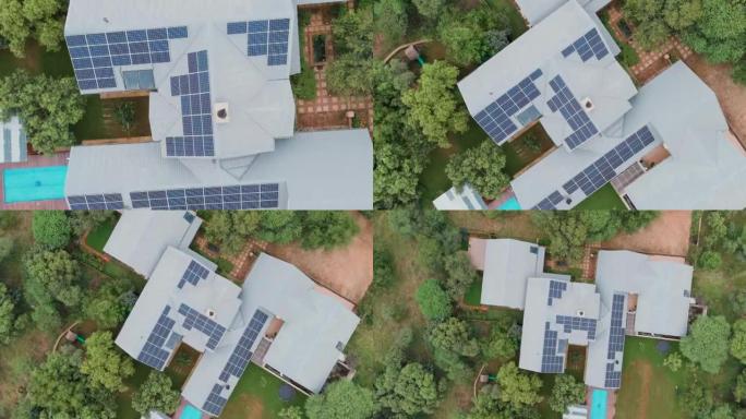 郊区房屋屋顶的圆形鸟瞰图，屋顶上有大量的光伏太阳能电池板，可在屋顶上提供能量
