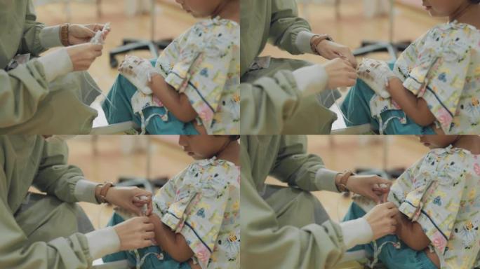 护士将静脉导管插入儿童患者的手。
