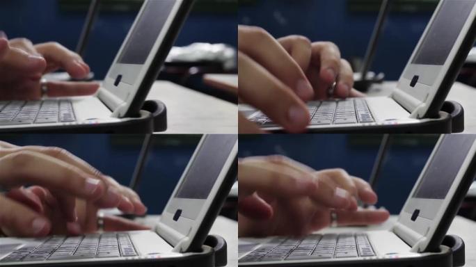 一个中学男孩在电脑上打字的手。特写。4k分辨率。