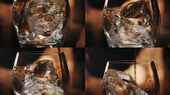 专业调酒师的Macro正在将专业的水晶冰块混合在玻璃杯中，同时在酒吧或迪斯科俱乐部为顾客准备酒精鸡尾