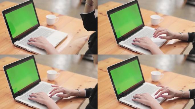 在带有绿色屏幕的数字平板电脑上书写的手的特写