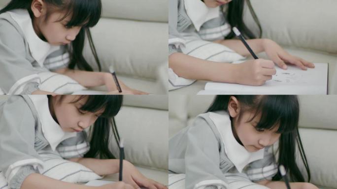 长发刘海可爱的亚洲女孩正在画自己的全家福，意图躺在肚子上。