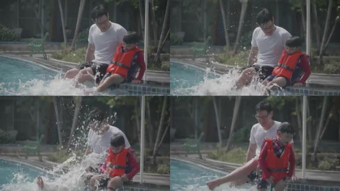 父亲正在与儿子在游泳池里游泳并玩耍