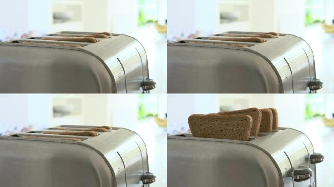 特写镜头显示吐司从烤面包机中弹出