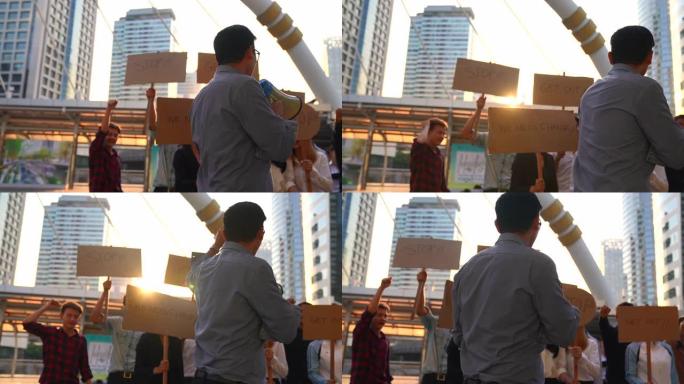 工人们在抗议，要求得到什么领导人在前面举着扩音器。