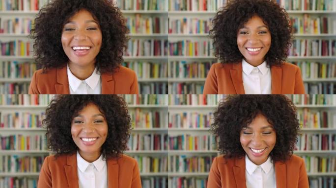 一位年轻快乐的黑人女性图书管理员对她的工作场所微笑和嘲笑。早晨学习前站在图书馆里的时尚，时尚和美丽的