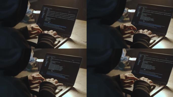 帽子和引擎盖中的黑客在笔记本电脑上键入程序代码