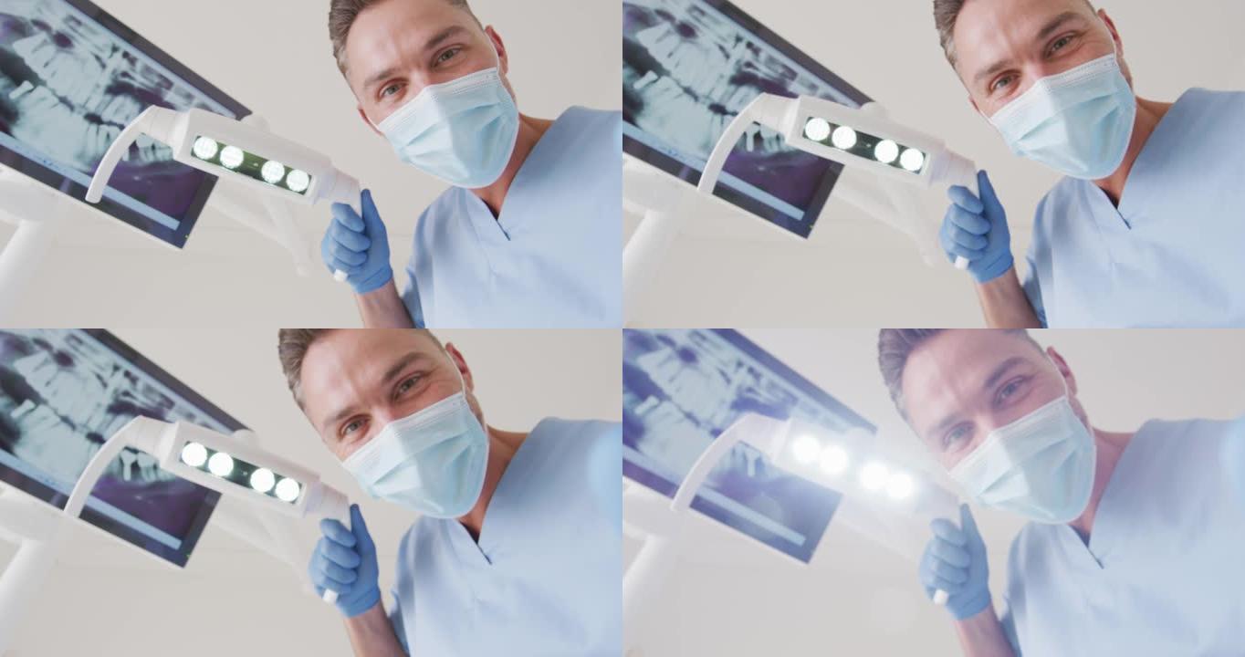 在现代牙科诊所用口罩检查牙齿的高加索男性牙医
