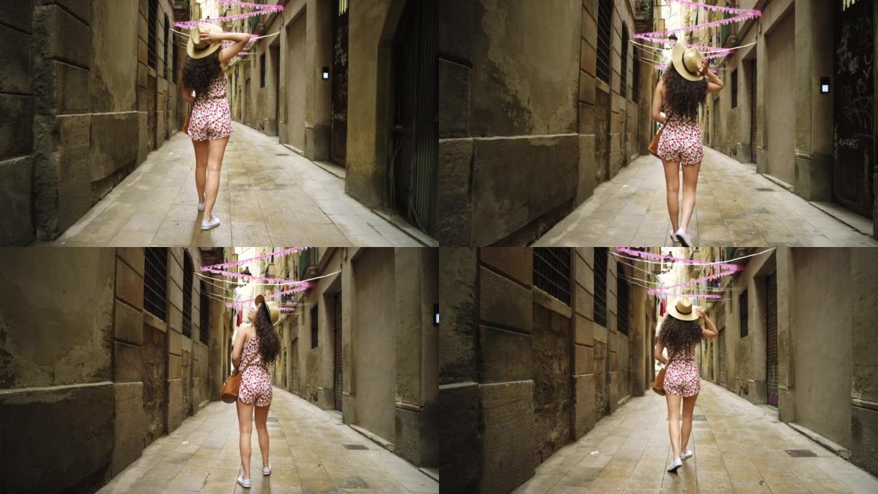 4k视频片段，一名年轻女子独自走过巴塞罗那的街道