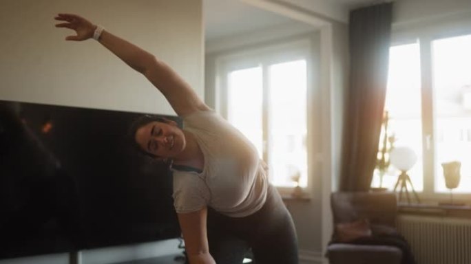 女人在家锻炼瑜伽胖子热身伸展