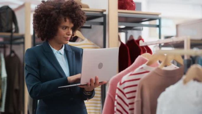 服装店: 女性商品经理使用笔记本电脑创建时尚的时装系列。专业商店销售零售助理检查库存。小企业主订购商