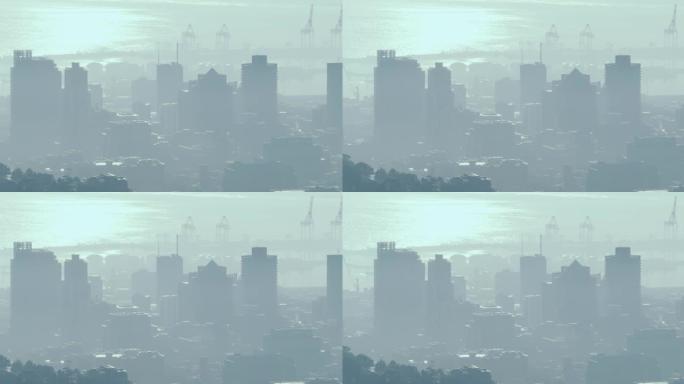 城市景观的总体景观，多个现代建筑和造船厂被烟雾覆盖