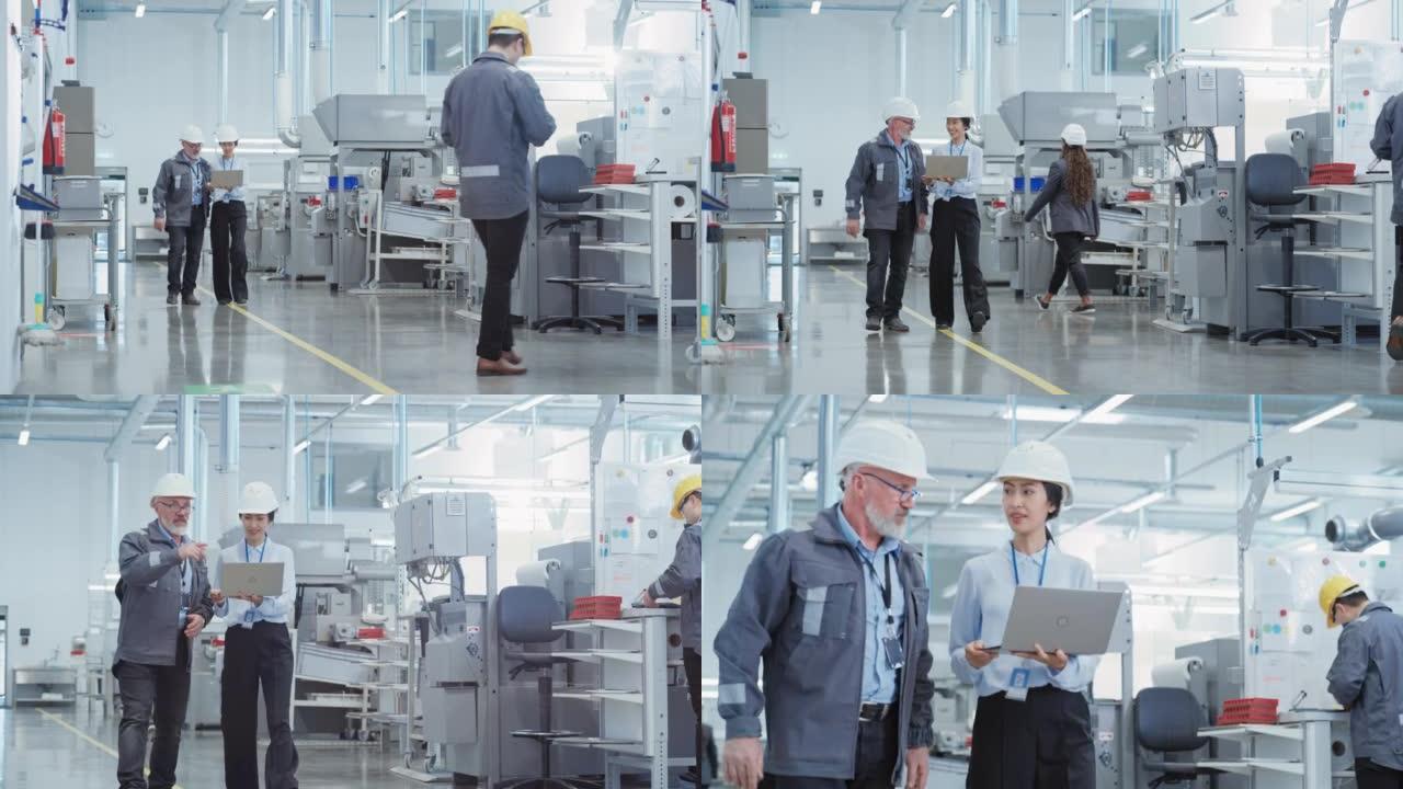两名专业的重工业员工在工厂戴着安全帽。步行和讨论工业机器设施，使用笔记本电脑。工作中的亚洲工程师和技