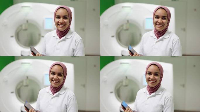 微笑的穆斯林年轻女医生站在MRI扫描室的肖像